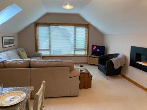 ein Wohnzimmer mit Sofa und Fernseher in der Unterkunft Enegar Accommodation in Stromness