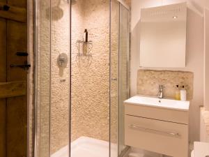 a bathroom with a shower and a sink at Miller Cottage a luxury 1550's cottage in the Historic centre of Saffron Walden in Saffron Walden +31 photos