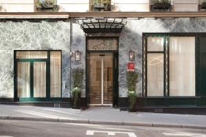 a building with a door on the side of a street at Grand Hotel Saint Michel in Paris