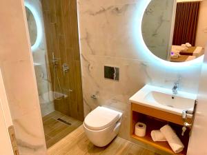 a bathroom with a toilet and a sink and a mirror at Vila Bello in Ksamil +82 photos