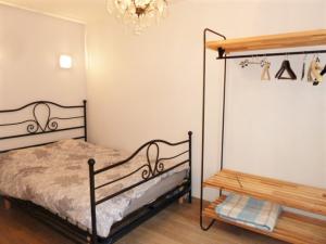 a bedroom with a bed and a chandelier at Armonui Honfleur centre historique in Honfleur