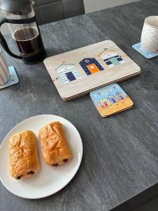 a white plate with two pieces of bread on a table at Seaside Apartment - 2 storey 2 bedrooms in Ballycastle