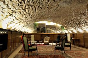 a lobby with chairs and a table and a mirror at Hôtel Le Boulevardier in Lyon