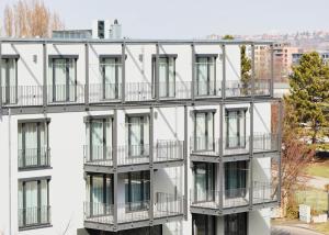 an apartment building with balconies on the side at livisit bergapartments in Stuttgart