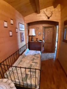 a bedroom with a bed in a room with wooden walls at La Casetta di Ross in Castellina Marittima +42 photos