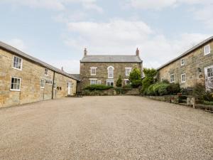an empty driveway in front of a brick building at Byre Cottage in Whitby