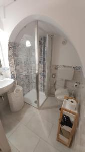 a bathroom with a shower and a toilet and a sink at Il Vicolo b&b in Putignano