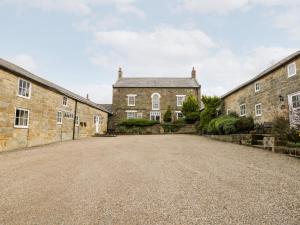 an empty driveway in front of a brick building at Forge Cottage in Whitby