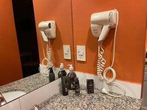 a bathroom counter with two hair dryers and a phone at Apart 9 de julio in Salta
