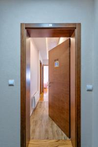 a door leading to a hallway in a room at Apartman Tajena in Zlatibor