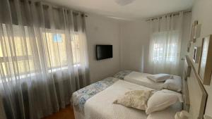 A bed or beds in a room at Malagueta Playa Azul Mediterraneo
