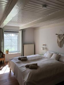 a bedroom with a large bed with two pillows on it at Ferienwohnung im idyllischen Gulfhof in Krummhörn