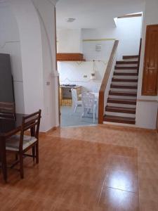 a living room with a staircase and a table and chairs at Villa luxueuse meublée in Sfax