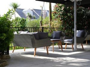 a group of chairs and a table and an umbrella at St Marys Hall Hotel in Hugh Town