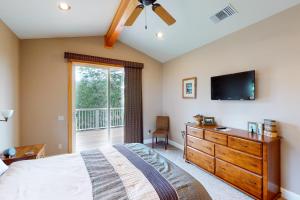 a bedroom with a bed and a tv and a dresser at Murray Lake Retreat in Bass Lake