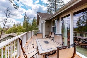 a deck with a table and chairs on a porch at Murray Lake Retreat in Bass Lake