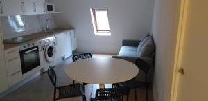 a small apartment with a table and a kitchen at APARTAMENTOS DON MANUEL D in Cee +6 photos
