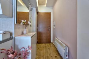 a hallway with a wooden door and a stairway with a vase at Apartman Tajena in Zlatibor +48 photos