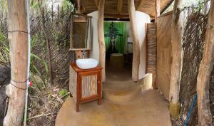 a bathroom with a tub, sink, and toilet at El Zopilote in Balgue
