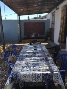 a table with a blue and white table cloth on it at Casita Colibrí in La Puebla de Montalbán