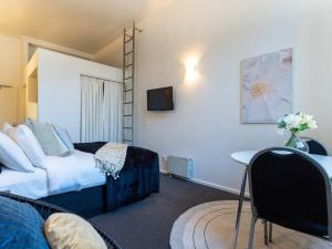 um quarto de hotel com uma cama e uma secretária em Bright CBD Studio -Near SkyTower - WiFi - Cityscape em Auckland
