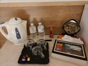 a counter with a kettle and a picture of water bottles at B&B Le Reclus in Mont-de-l'Enclus