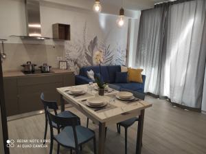 a living room with a table and a blue couch at BLU apartment in Civitanova Marche