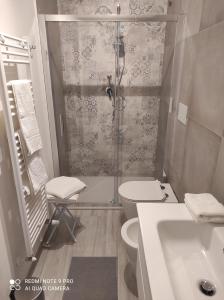 a bathroom with a shower and a toilet and a sink at BLU apartment in Civitanova Marche +9 photos