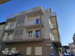 an apartment building with balconies on a street at BLU apartment in Civitanova Marche