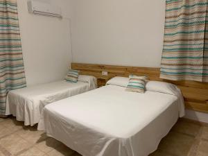 Postel nebo postele na pokoji v ubytování Hostal Barbate