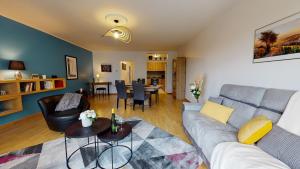 a living room with a couch and a table at Le Nid Cosy + 1 Garage in Colmar