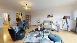 a living room with a couch and a table at Le Nid Cosy + 1 Garage in Colmar