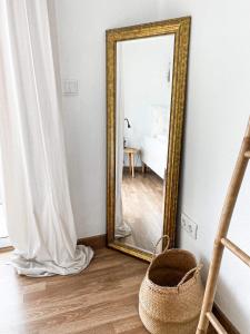 a mirror on a wall in a room at Ocean House Ericeira in Ericeira