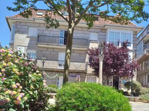 a building with a tree in front of it at A Casa da Herba in Redondela