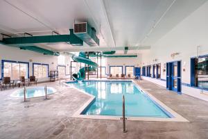 a swimming pool with a slide in a building at Canalta Rocky Mountain House in Rocky Mountain House