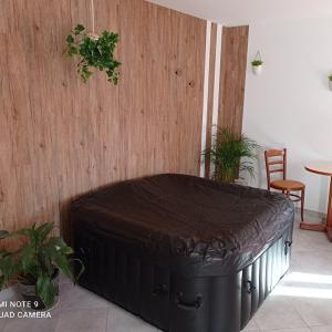 a large black suitcase sitting in a room at Auberge du pèlerin in Saint-Vincent