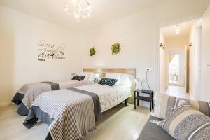 a bedroom with two beds and a couch at Atico la casa de Tudela in Tudela