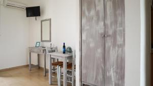 a bathroom with a vanity and a sink and a mirror at Pittas Studios in Kardamaina