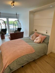 een slaapkamer met een bed met 2 kussens erop bij Guadeloupe in Oostende