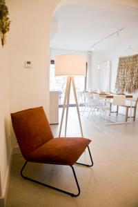 a living room with a chair and a table at Vakantiewoning Spoor 23 in Borgloon