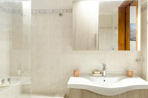 a bathroom with a sink and a mirror and a tub at Chrysa House Kissamos in Kissamos +34 photos