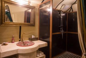 a bathroom with a sink and a shower at Luxury Desert Camp Amanar in Merzouga +37 photos