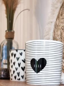 a black and white container with a heart painted on it at Holiday Home Sofia La vie est belle in Bollendorf