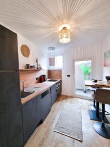 a kitchen with a sink and a table at Holiday Home Sofia La vie est belle in Bollendorf