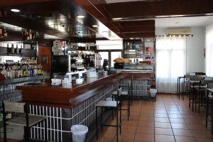 a bar with a wooden counter in a restaurant at NUESTRA SEÑORA DEL PINAR in Galve de Sorbe
