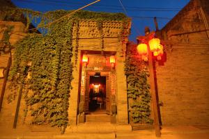 a building with ivy growing on the side of it at Pingyao Laochenggen Inn in Pingyao