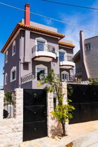 a house with black garage doors in front of it at Ozone Complex by A&D Properties in Porto Rafti