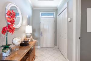 a hallway with a table and a mirror and a door at The Whart Unit 505 condo in Orange Beach