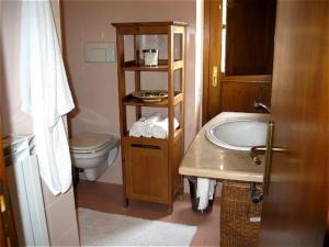 a small bathroom with a sink and a toilet at LaCollinaTuscany between San Gimignano and Volterra in Volterra