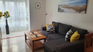 a living room with a couch and a table at Os Castelos Playa de Covas in Viveiro